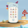 A light blue baby phone toy with various buttons and a heart icon is shown on a wooden surface.
