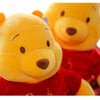 A yellow plush toy resembling Winnie the Pooh is shown in a close-up shot.