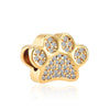 Gold-toned charm bracelet featuring elephant, key, butterfly, and heart pendants.
