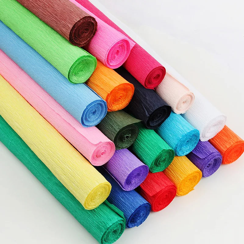 A collection of colorful crepe paper rolls in various shades, arranged diagonally.