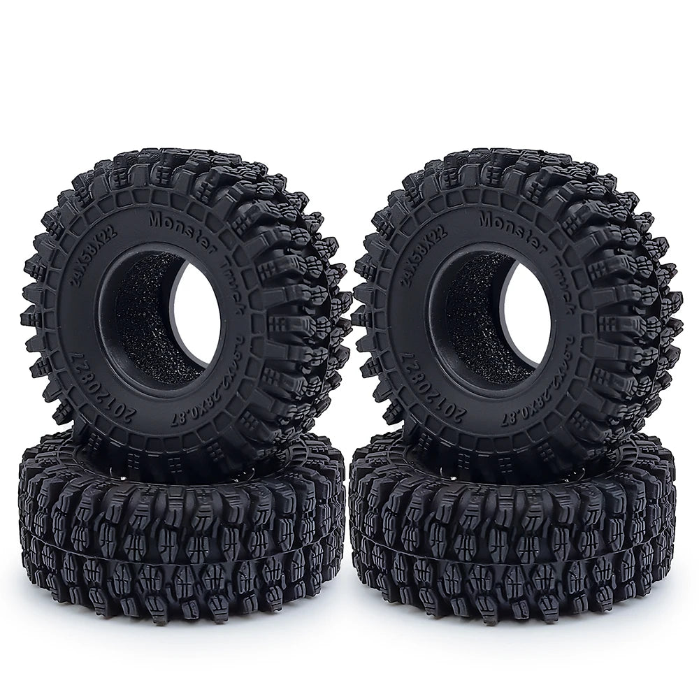 Une paire de pneus en caoutchouc souple noirs Monster pour voitures crawler RC, empilés.