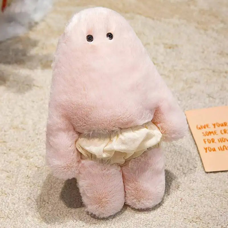 A soft pink Kawaii monster plush doll with a belly and pants is shown on a light-colored carpet.