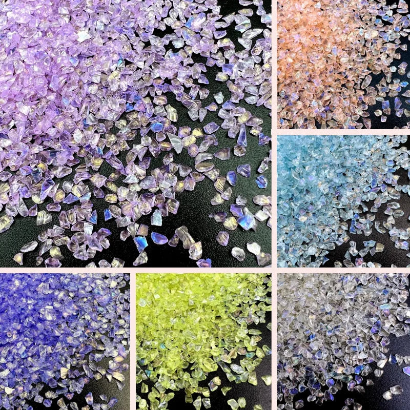 A collection of crushed glass crystals in various colors including purple, orange, blue, and green.
