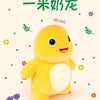 A yellow, smiling dinosaur plush toy with large eyes and a happy expression against a white background.