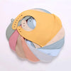 A stack of pastel silicone baby bibs in shades of yellow, pink, and blue with catch pockets.