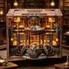 A detailed wooden miniature library model featuring shelves, stairs, and a central dome with an illuminated figure.