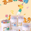 A set of silky crayon tubes and a plastic pencil is displayed on a wooden surface with colorful paper.