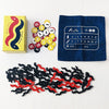 A collection of game components including a box, numbered discs, and black and red plastic pieces for a board game.