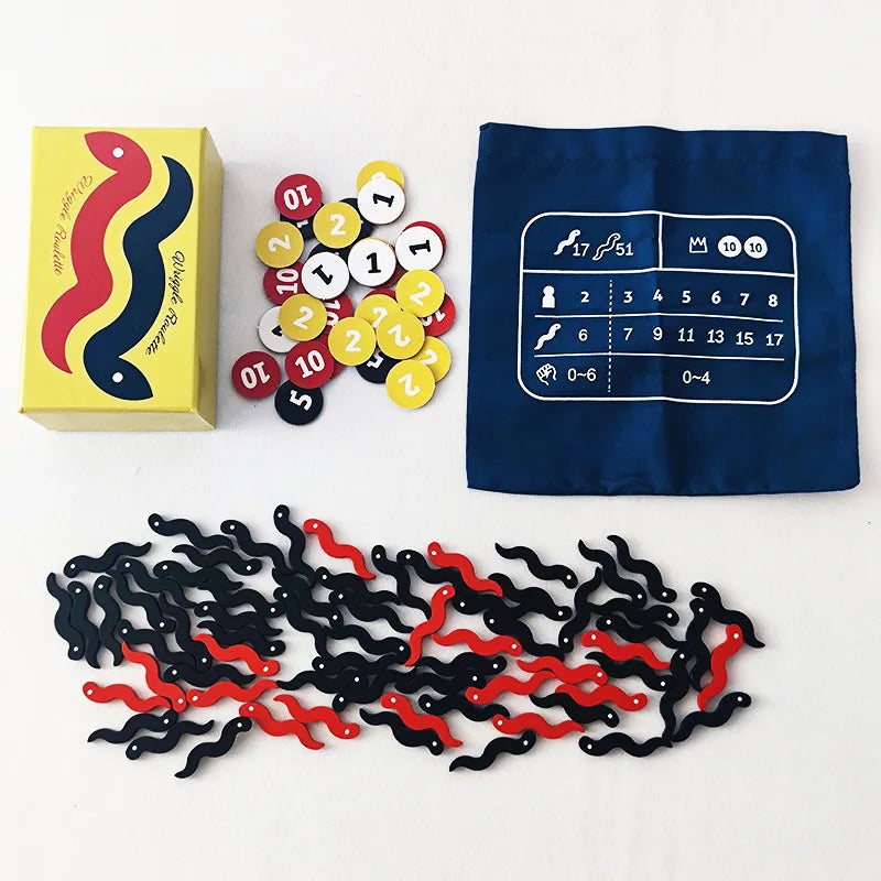 A collection of game components including a box, numbered discs, and black and red plastic pieces for a board game.