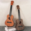 A wooden ukulele toy with adjustable tuning pegs is displayed against a light background.