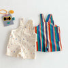 A pair of colorful striped kids overalls featuring a raindrop print, laid flat on a white surface.