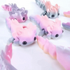 A set of eight colorful flexible salamander figurines in shades of pink and gray