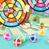 A cartoon animal character is shown holding a dart board with colored sticky balls, surrounded by various colorful balls on a