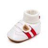 White baby booties with a ribbed cuff and red stripes on the toe area
