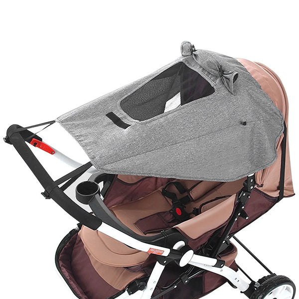 A gray sun shade canopy for a universal baby stroller is shown in a folded state.