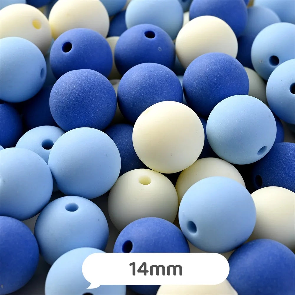 A close-up view of various pastel blue and white bear-shaped acrylic craft beads.