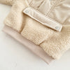A beige toddler winter coat with a half-zip collar and fluffy sherpa lining.