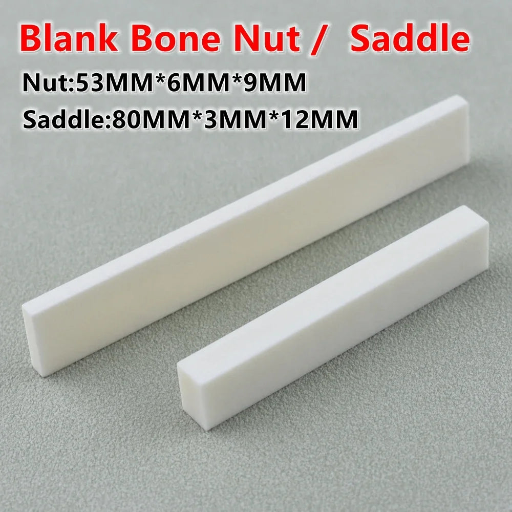 White blank bone nut and saddle pieces shown diagonally on a gray surface
