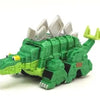A green die-cast dinosaur truck toy with removable dino figure and accessories.