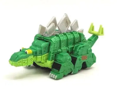 A green die-cast dinosaur truck toy with removable dino figure and accessories.