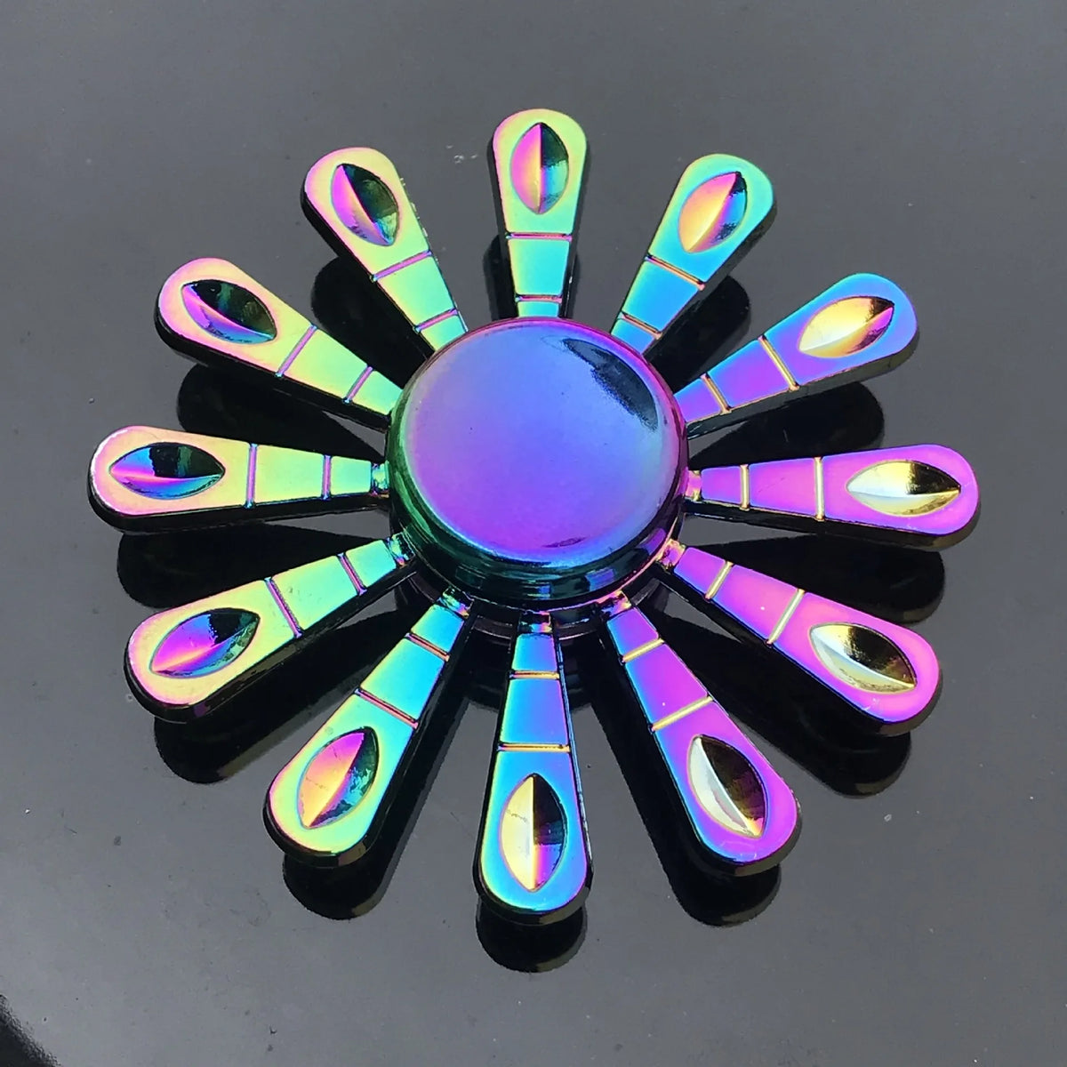 A rainbow metal fidget spinner with smooth silent rotation, featuring multiple iridescent blades.