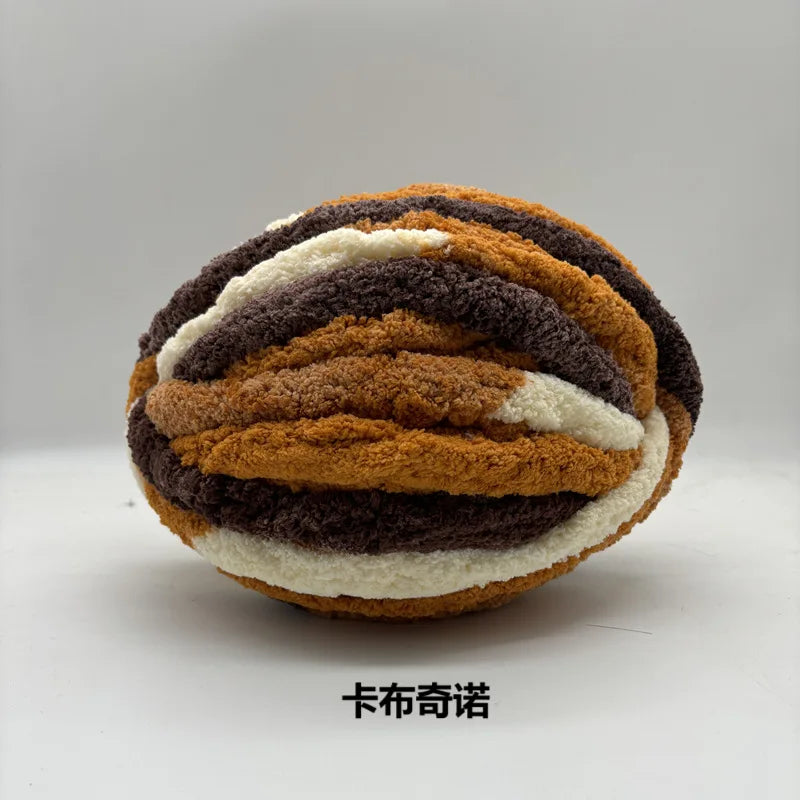 A ball of chunky chenille yarn in horizontal stripes of brown, gray, and cream.