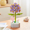 A building block bouquet set featuring purple and yellow rose flowers on a green stem.
