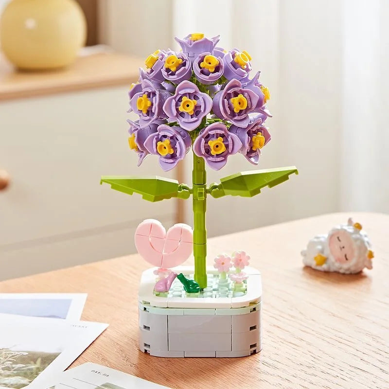 A building block bouquet set featuring purple and yellow rose flowers on a green stem.