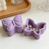 A purple silicone resin mold shaped like a butterfly with a lid, used for DIY jewelry boxes.
