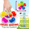 A hand is sorting colorful squishy toys for toddlers, demonstrating color sorting and fine motor skills.