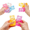 Hands are squeezing colorful bear-shaped stress relief fidget toys in various shades of pink, yellow, and blue.