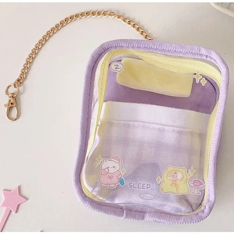 A purple storage pouch with a yellow interior and a pink keychain attached to the strap.
