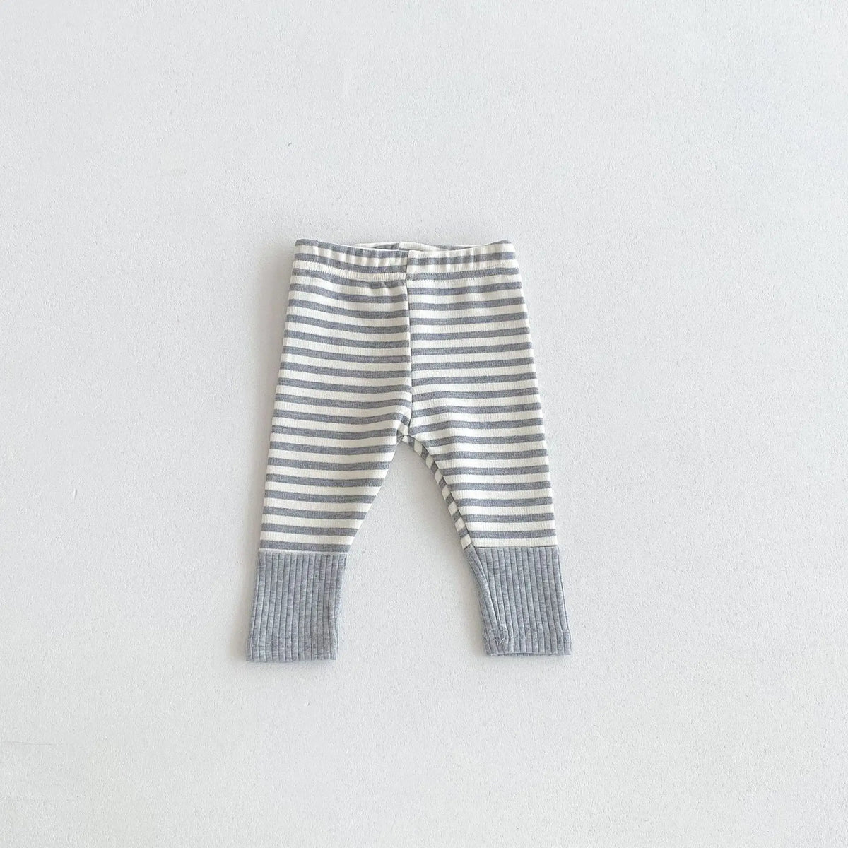 Gray and white striped soft cotton baby leggings with a spliced design