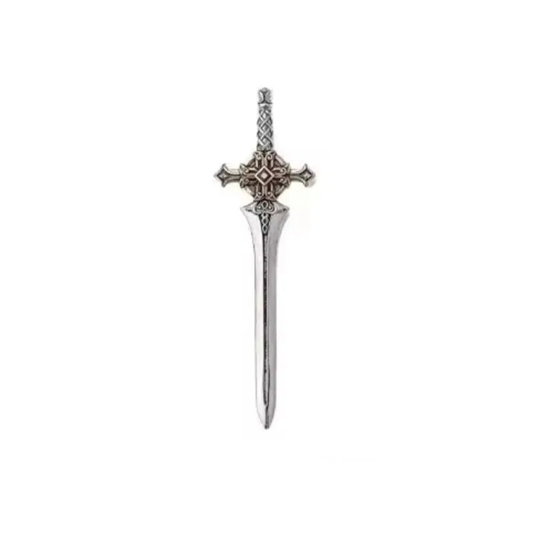 A silver magnetic metal figurine of an adjudicator cross with a detailed design.