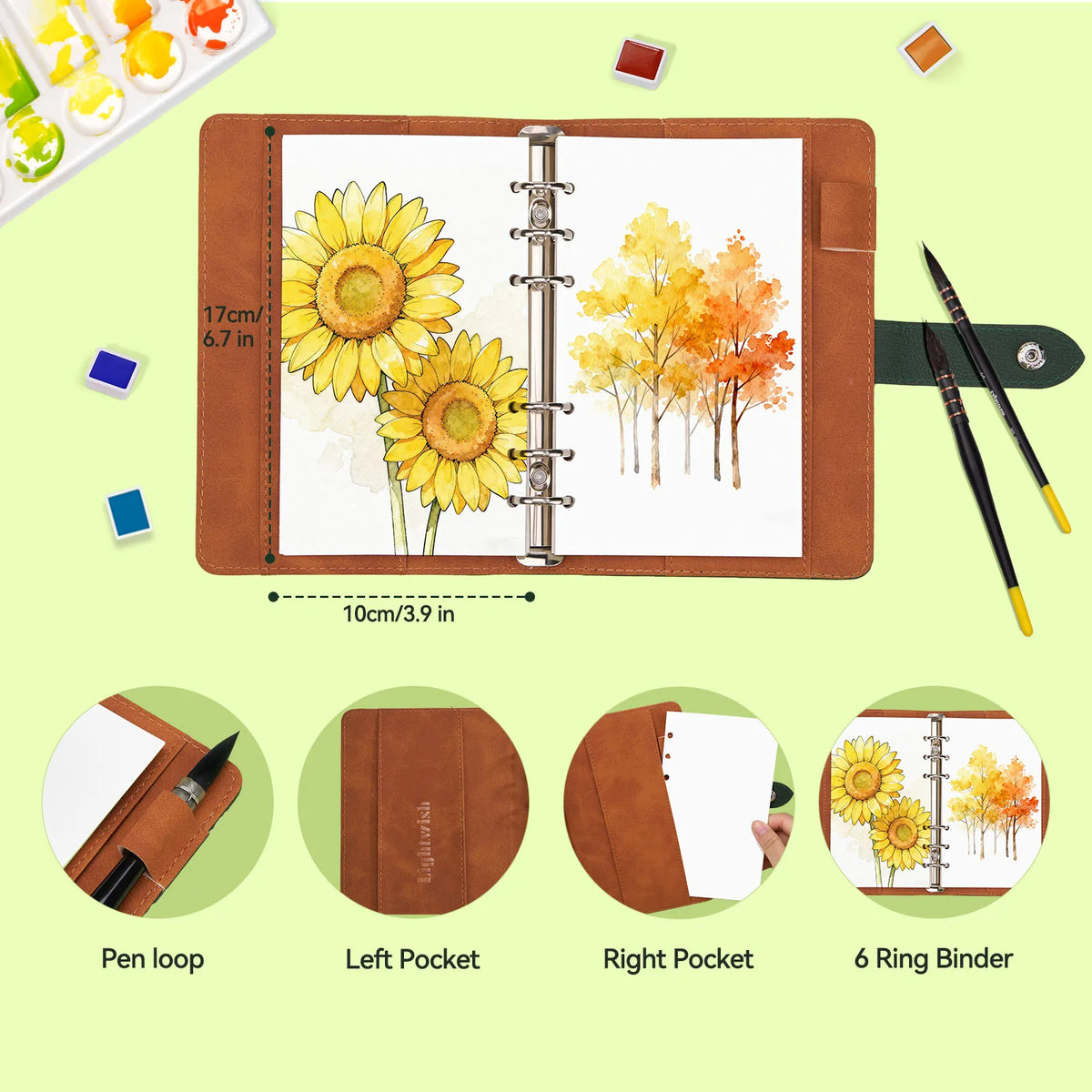 A brown watercolor sketchbook with a lay-flat binding showing floral and autumn nature illustrations.