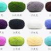 A collection of pre-dyed milk cotton yarn in various colors and shades, displayed in a row.