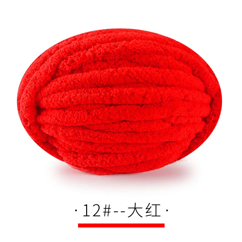 A ball of bright red chunky chenille yarn for hand knitting projects.