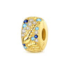Gold-toned charm pendant featuring a swirling design with blue and clear gemstones.