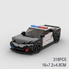 A black and white classic rally car building block set with red and blue lights.