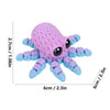 A purple 3D printed articulated octopus fridge magnet with large black eyes.