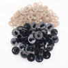 A pile of black plastic safety eyes with washers for crafting and stuffed animals