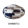 A ball of chunky chenille yarn with a mottled pattern of gray, white, and dark blue.