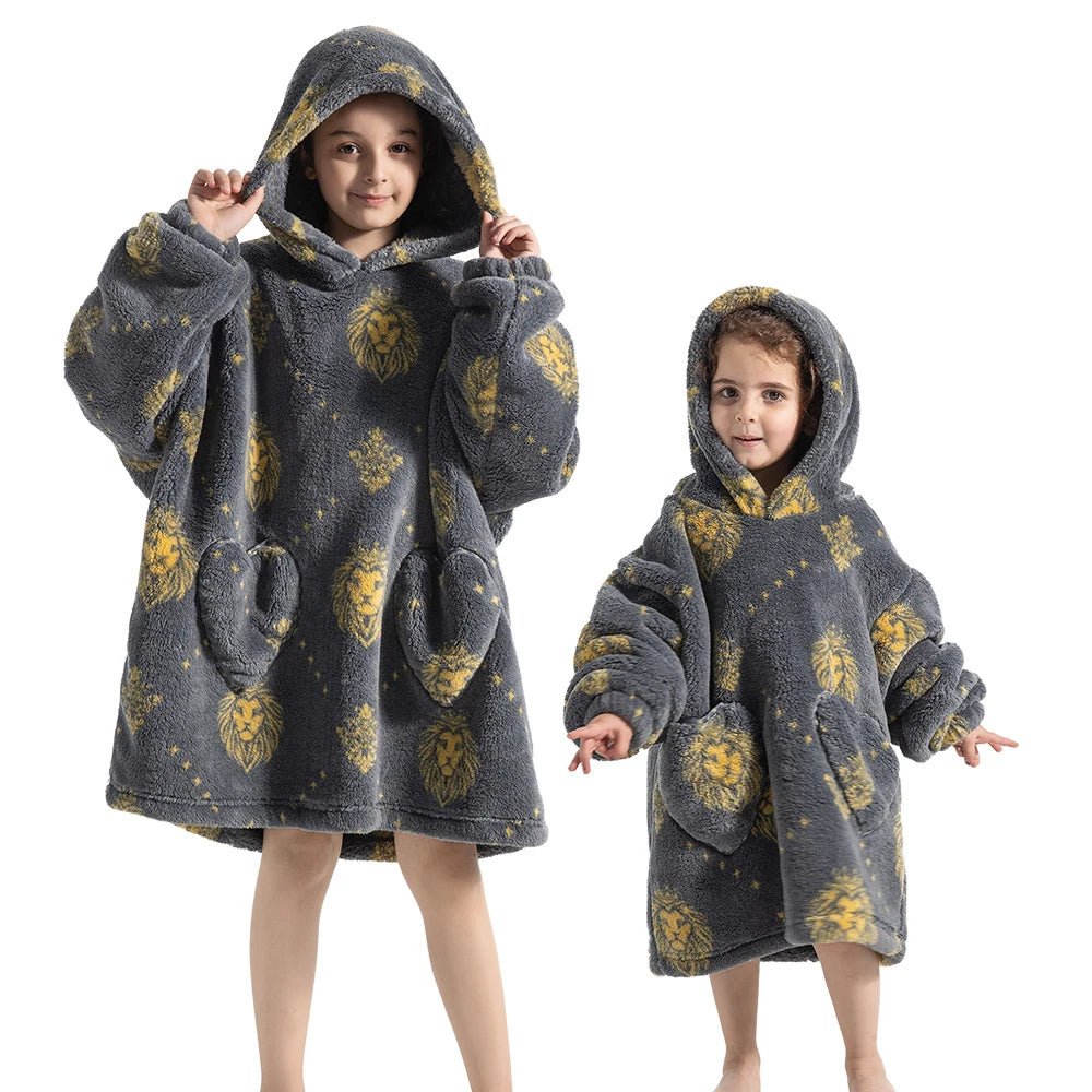 A young girl models a gray and yellow patterned cozy kids flannel hoodie sweater.