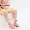 Pink cartoon animal non-slip socks for babies and toddlers shown on a child's foot.