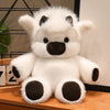 A white plush toy resembling a West Highland calf or running cow doll with dark accents.