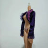 A mannequin displays a purple and purple-pink sheer ruffled shawl over a nude colored garment.