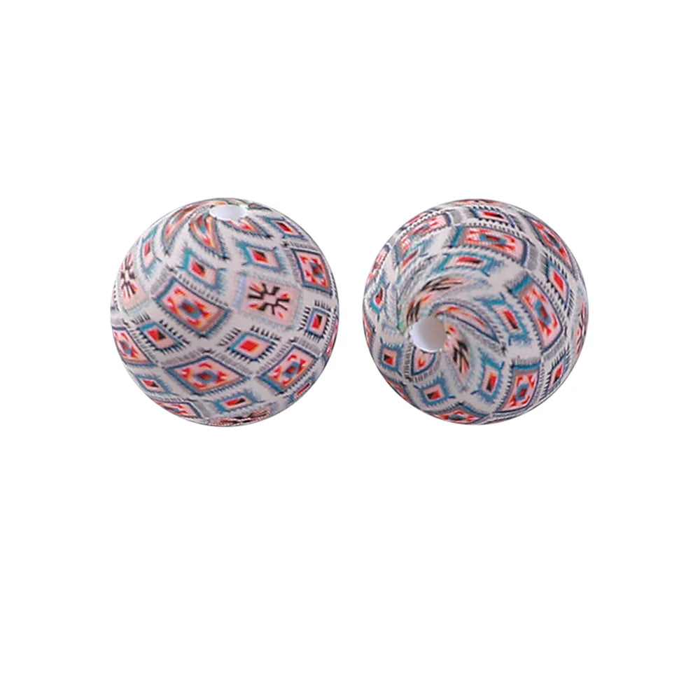 A pair of round, patterned silicone beads for jewelry making and DIY crafts.