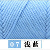 A close-up view of light blue premium milk cotton yarn showing a diagonal knit pattern.