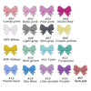 A collection of silicone bow tie beads in various shades including pink, gray, yellow, and blue for jewelry making