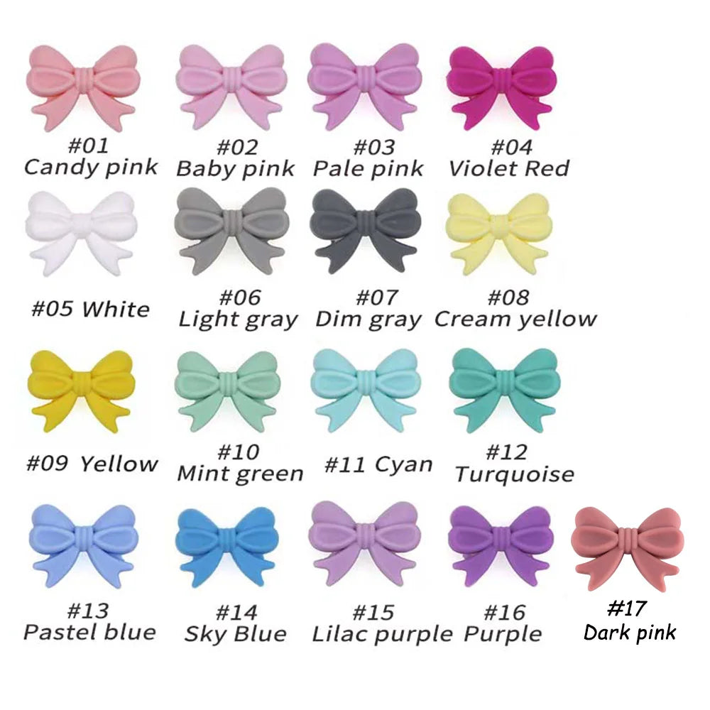 A collection of silicone bow tie beads in various shades including pink, gray, yellow, and blue for jewelry making